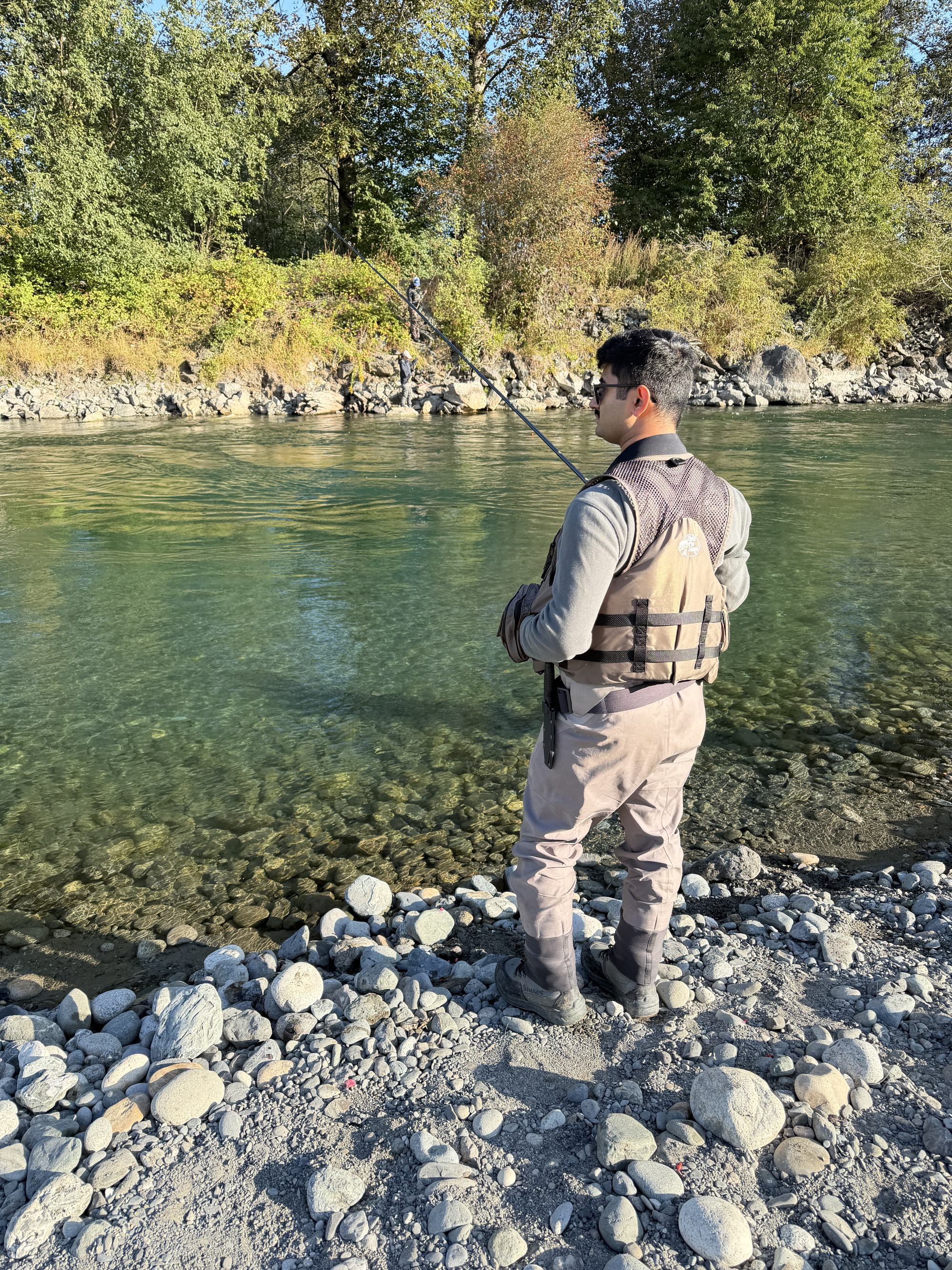 Aneesh casting into a river